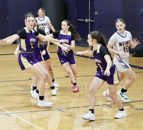 Lady Comanches Evy Johnson (left), Emersyn Boehm (middle) and Marie Johnson (right) in action against Weimar on Friday. Photo courtesy of Louann Heinhsohn.