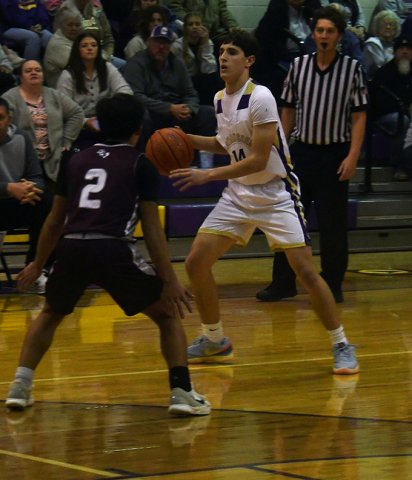 Jake Simper with a first-half dribble against Flatonia on Jan. 27. He made three treys and scored 11 points. Photo by Mark Lube.
