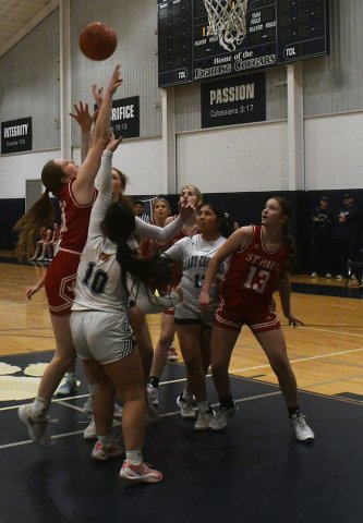 Addy Matias (left) fights for a rebound in the game at Victoria Faith Academy on Friday. Photo by Mark Lube.