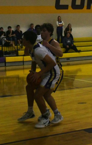 Weimar tries to contain Felix Nieto in the paint. They were not successful limiting him on the scoreboard as he netted 22 points in the Shiner win. Photo by Mark Lube.