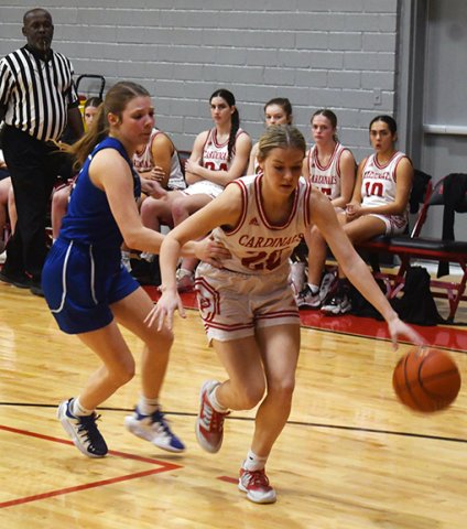 Kristin Cerny dribbles away from a Sacred Heart player during the second half of the Lady Cards’ 36-15 win to close out the regular season. The senior led all scorers with 12 points and made two triples. Photo by Mark Lube.