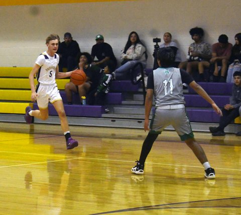 Shiner senior Boe Boehm faces a Bloomington player during the first half of Friday’s home game. Boehm contributed six points.  Photo by Mark Lube.