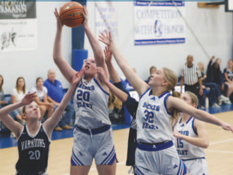 Photo by Chuck Grafe Ashten Schaefer (20) grabs a rebound in the Bracken victory.