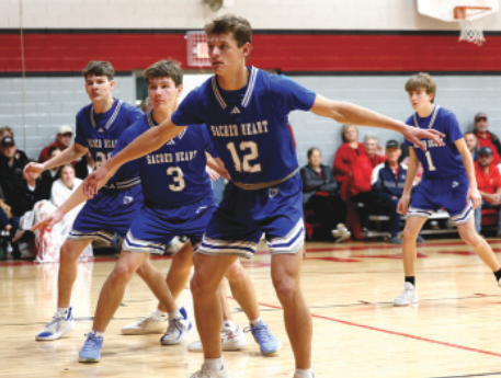 Photo by Chuck Grafe From left, Jayden Schindler, Kolby Haas and Layne Sevcik defends an inbounds play.