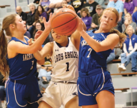 Photo by Chuck Grafe Alli Clark left, and Kenzie Chance fight for the possession of the basketball.