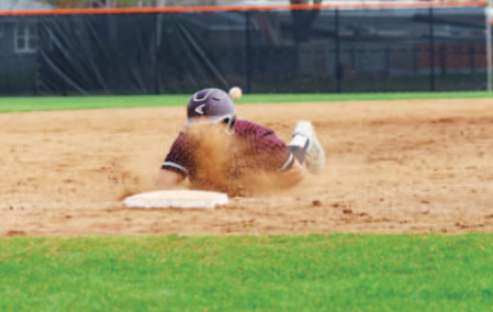 Photo by Chuck Grafe Brennan Henneke slides into third in the Gonzales game.