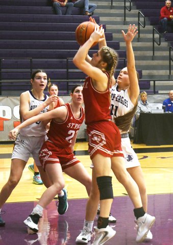 Bryan St. Joseph defends senior Riley Mozisek while Ashlin DeSarro gets involved as well in the TAPPS 2A state semifinal Feb. 25 at Waco University High School. Photo by Mark Lube.