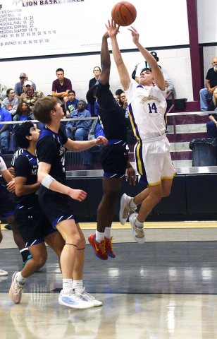 Mumford blocks a Jake Simper shot in the first half. Photo by Mark Lube.