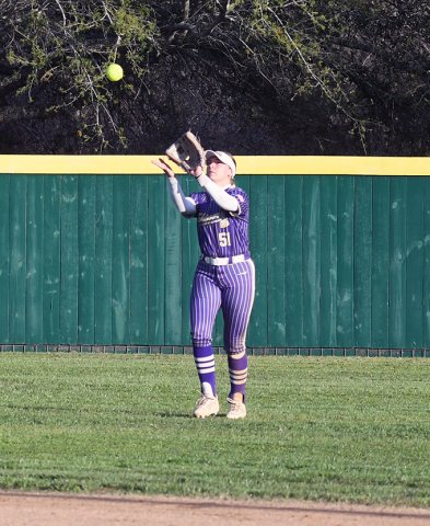 Center fielder Hailey Radicke eyes a fly ball in the Weimar game on March 17. She had one putout and on the other side of the ball, had two doubles and scored twice. Photo by Mark Lube.