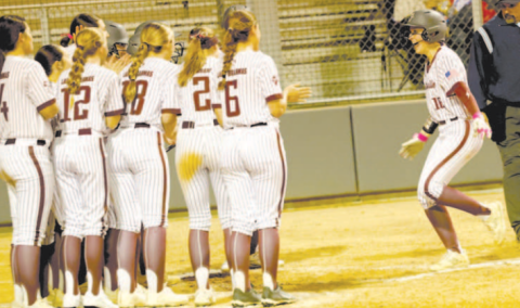Photos by Chuck Grafe Grace Halata is greeted at home plate after hitting her first home run of the season.