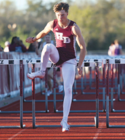 Photo by Chuck Grafe Creek Burnes clears the last hurdle en route to first place in the 110s.
