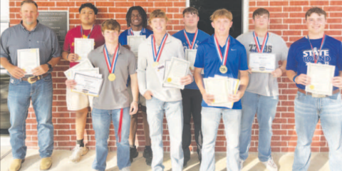 Pictured are members of the Yoakum High School State Football Team with certificates and medals and Head Coach Bo Robinson at the Yoakum ISD School Board meeting April 13.