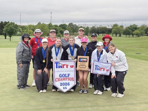 The St. Paul girls and boys golf teams along with the coaches pose with the girls 2A state banner and plaque. Photo courtesy of Nicco Brown.