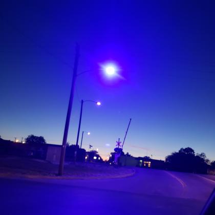 A streetlamp illuminates blue light at the intersection of East Gonzales and South Streets in Yoakum. Photo by Nadine Rex. 