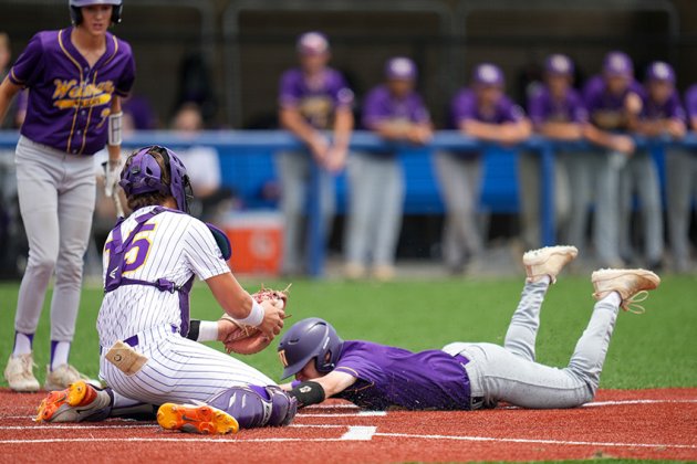 Senior Bryce Nerada tags out Weimar runner Brady Henke during a top-of-the-first steal attempt of home plate in the second game.  Photo courtesy of Howard Esse. 