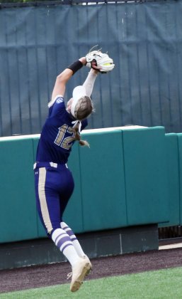 Freshman shortstop Addy Siegel with a leaping catch on a fly ball in third-base foul area in the second game on Saturday afternoon. Photo by Mark Lube.