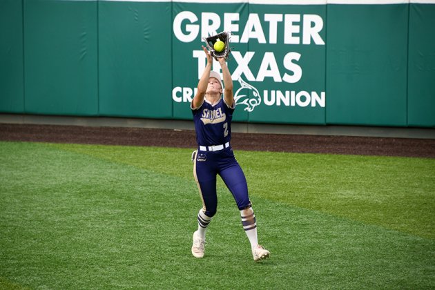 Sophomore right fielder Callie Sevcik catches a fly ball in the second game of the regional finals Saturday in San Marcos. Photo by Mark Lube.