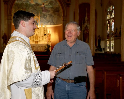Using wood from the old Shiner church steeple which he got during one of the church's renovations, Harvey Picha constructed a crucifix for Ryan Kapavik.-to-be