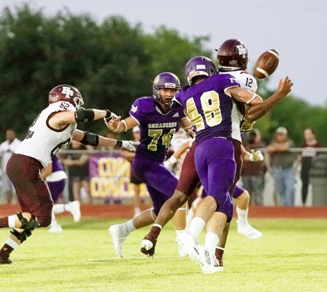Comanche Kyle Muehlstein hits Brahma quarterback Jorian Wilson, causing a fumble. Jared Werner also applies pressue. Photo by Photos by Lori Raabe.