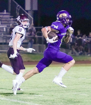 Trace Bishop bursts into the secondary Friday against Hallettsville during his long run of 56 yards. Photo by Photos by Lori Raabe.