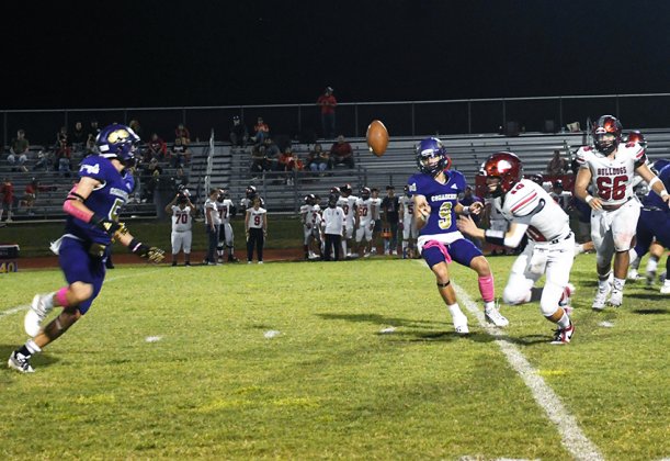Quarterback Carson Schuette (9) flips the football to running back Trace Bishop (left) on an option play that resulted in a 29-yard touchdown run for Bishop in Shiner’s 45-30 win over Three Rivers on Friday. Photo by Mark Lube.