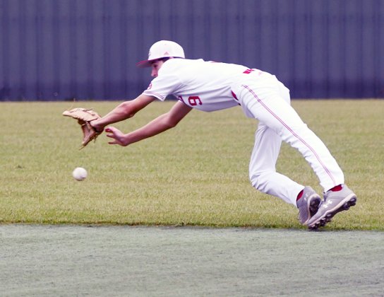 Cardinal second baseman Cody Malinovsky makes an acorbatic dive for this slightly-above-the-ground ball April 23 against Bryan St. Joseph in the bi-district round. St. Paul won the game 2-0. Photo by Mark Lube.