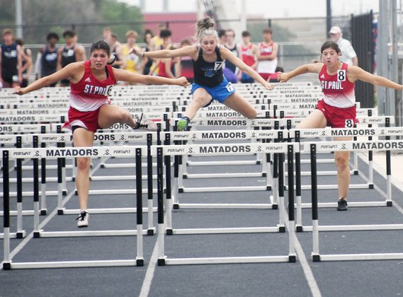 Petra Kock (left) and Gabby Rodriguez (right) leap over the hurdles during the 100-meter hurdles event Friday in the TAPPS South Regional track meet in Seguin. Koch was second with 17.48 seconds and Rodriguez came in seventh place.  Photo by Mark Lube.
