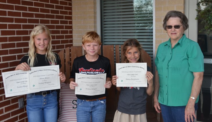 Lavaca Soil and Water Conservation District 13 selected its school wide 13 and under essay winners from Shiner Catholic School, who include from left Tenley Wagner (1st), Kolton Wilgus (2nd), Emma Bargmann (3rd) and LSWCD secretary, Dorothy Henke. Photo by Jimmy Appelt