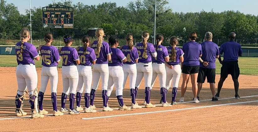 The Shiner Junior softball players and coaches/managers stand for the national anthem. Photo courtesy of Amanda Ulcak.