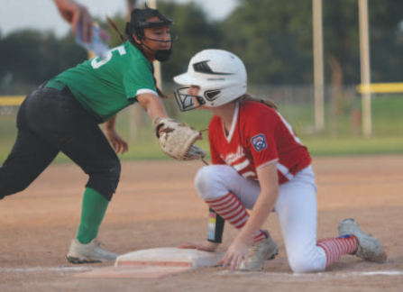 Photo by Chuck Grafe Cora Zidek gets back to first on a pick-off attempt in the title game.