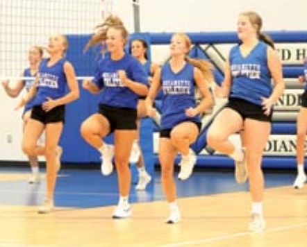 Photo by Chuck Grafe The Indianettes warm up before the first practice Monday afternoon..