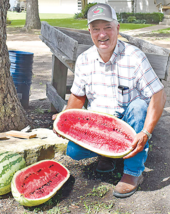 Blackie Bludau cuts open this watermelon at his home in Hallettsville. Bludau grows watermelons for sale annually.