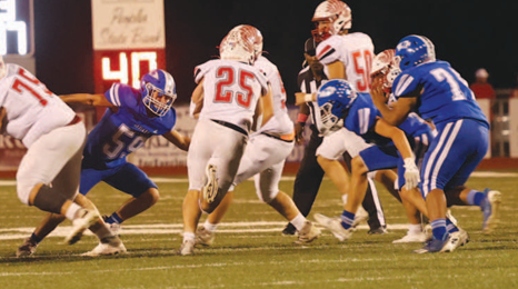 Photo by Chuck Grafe #59 Tatum Beach comes up to make the tackle on Carter Chilek