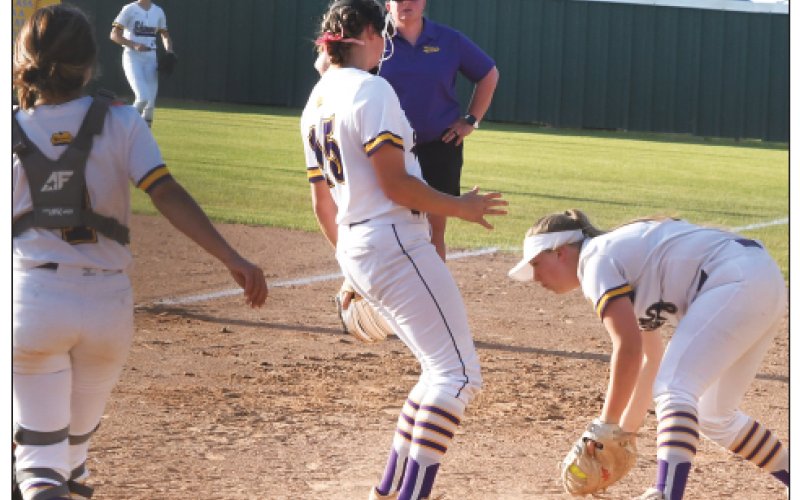 Lady Comanche first baseman Dyllan Chrismon catches the ball with pitcher Paeden Vincik (middle) and catcher Teresa Olivas providing backup. Photo by Mark Lube.