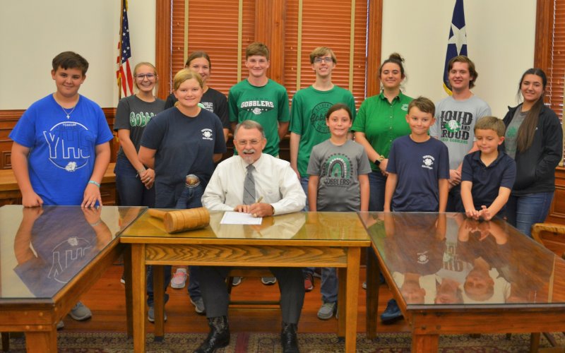 DeWitt County 4-H members pose with DeWitt County Judge Daryl Fowler as he recognizes the first week of October as National 4-H Week Sept. 26. Photo by Hans Lammeman.