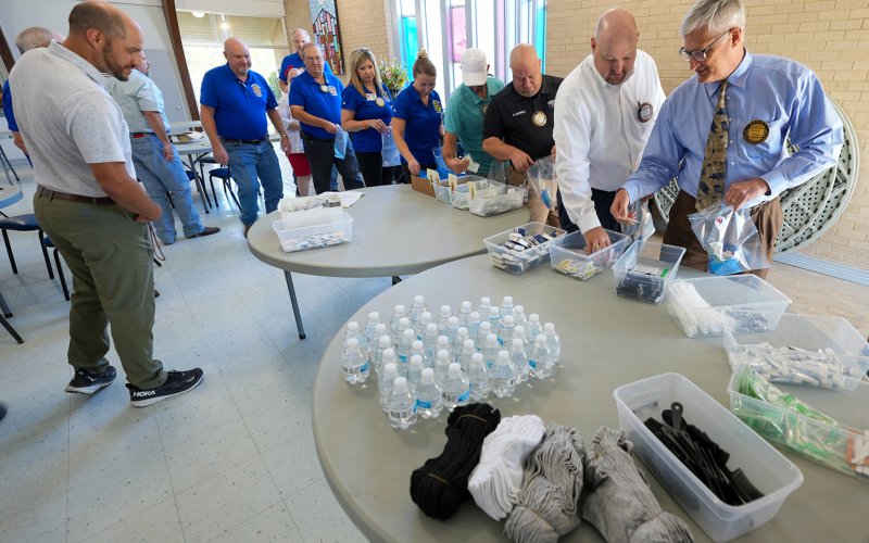 Members assembling supply bags for the homeless.