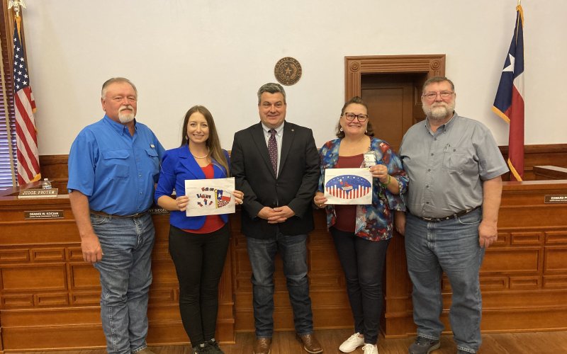 The winners of the “I Voted” and “Future Voter” coloring sticker contest, sponsored by the Lavaca County Elections Department, were Daniel Hernandez, 5th grade student at Moulton ISD, and John Moore, 10th grader at Shiner HS. Pictured are Commissioner Kenny Siegel, elections administrator Amy Kloesel, County Judge Keith Mudd, elections voter registrar, Brandy Stuckey, and Commissioner Dennis W. Kocian. Photo by Jimmy Appelt