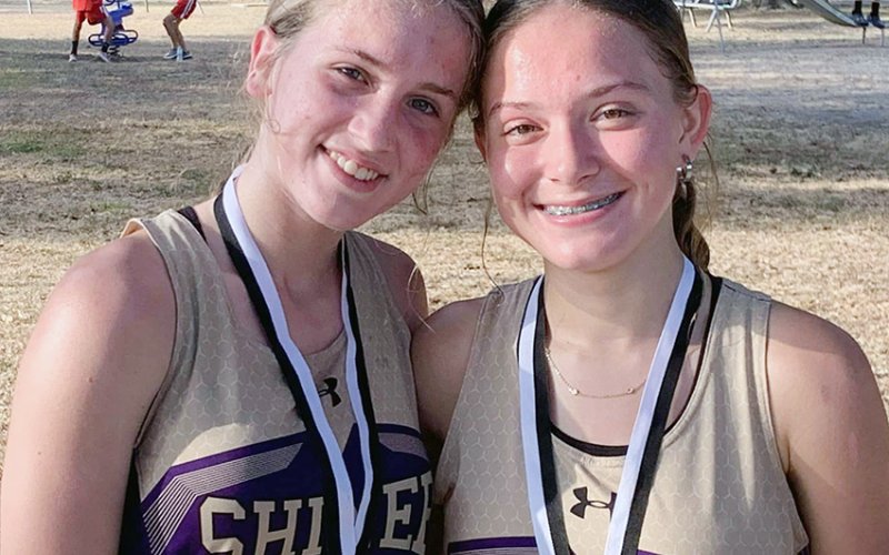 Hayleigh Burns (left) and Emma Joslin finished in fourth and No. 17, respectively, in the varsity girls 1A-2A race at the Moulton meet Saturday. Photo courtesy of Michelle Winkenwerder.
