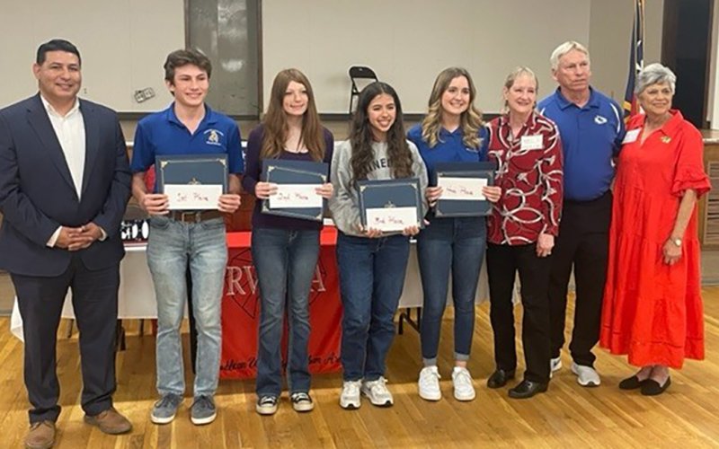 From left to right; Mark Longoria, First Place winner, Joseph Goodwyne, Second Place winner, Brealinn Finch, Third Place winner, Julia Barecky, Fourth Place winner, Ava Grace Matias, Teacher winner, Rick Masek pose with Representatives of the Republican Women of Yoakum.