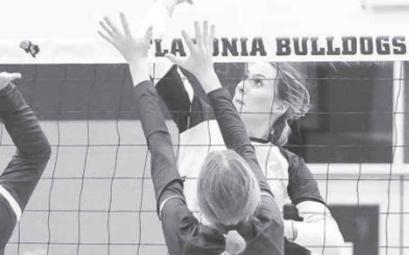 Addison Pekar tips the ball over the net for a point against Luling Lady Eagles.Photo courtesy of Raymond Rosas.