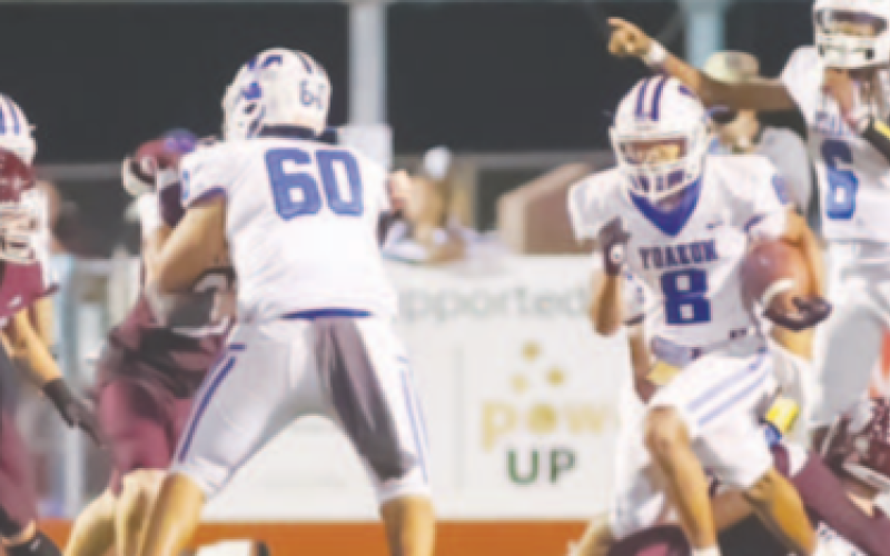Qyion Williams (8) runs with through a lane while Zach Taylor (6) and Oliver Ortiz (60) assist. Photo courtesy of Raymond Rosas.