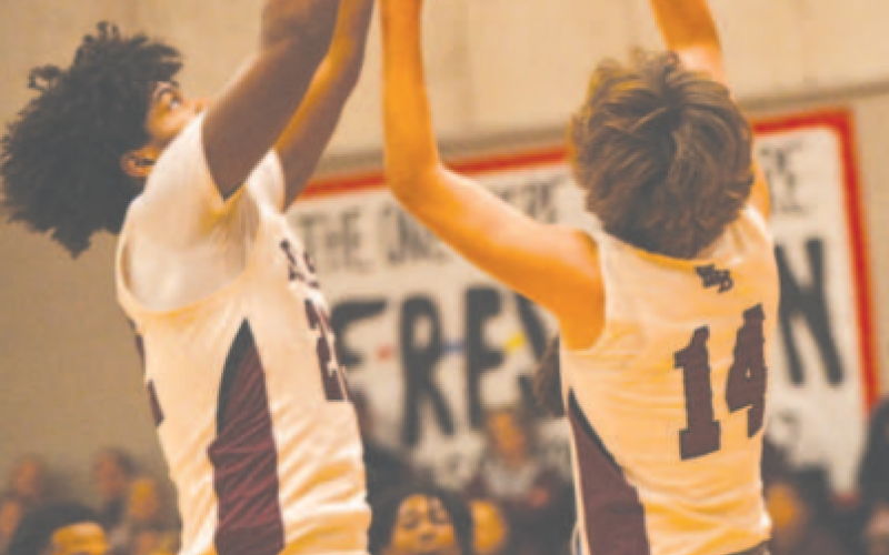 Kason Podhajsky (14) and Jorian Wilson have their eyes on a rebound. Chuck Grafe/Tribune- Herald
