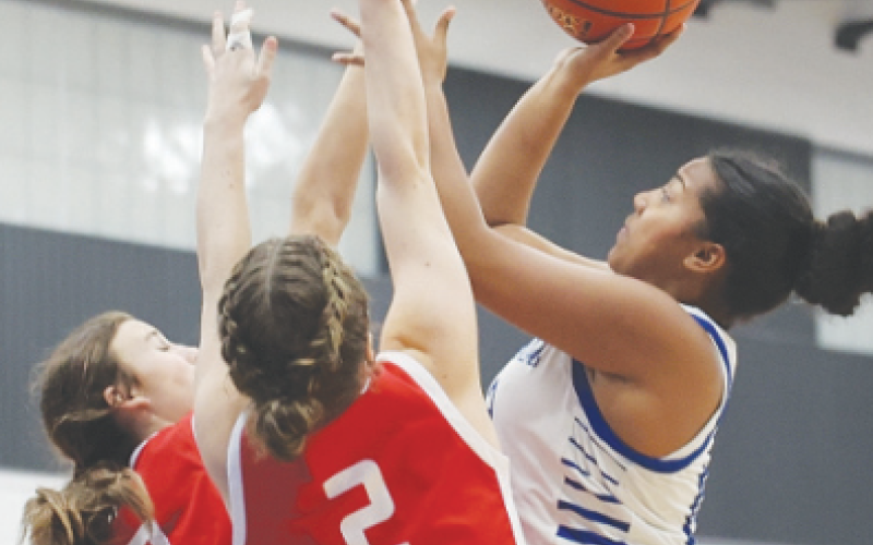Devaeh Rios attempts a shot during the basketball game against the Lady Cardinals. Photo courtesy of Raymond Rosas.
