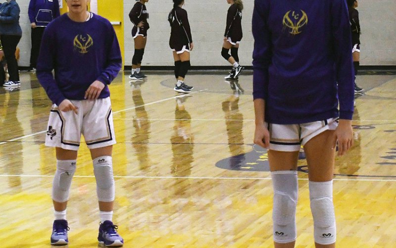 Brooke Palmer (left) and Morgan Lenehan (right) warm up prior to a recent home game. Shiner played its regular-season finale Tuesday at home to Louise. Photo by Mark Lube.