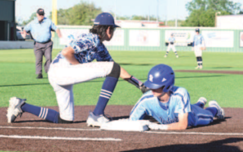 Hudson Kutac gets back to first in the first inning of the game with Bracken Christian. Chuck Grafe/Tribune-Herald