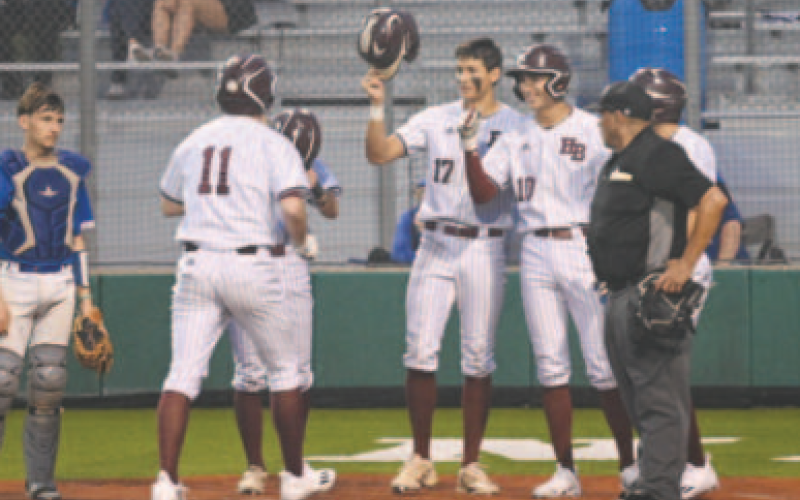 Josh Griffin (11) is greeted at home plate after his three-run homer in the third inning in Game 1. Chuck Grafe/Tribune-Herald