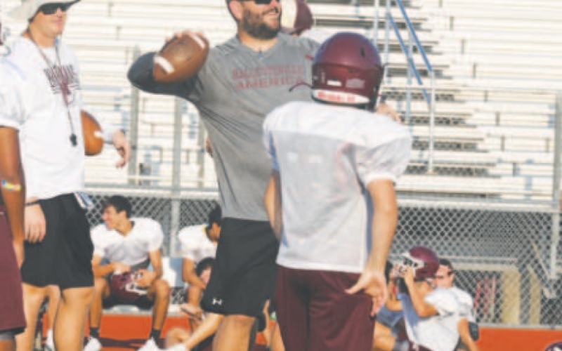 Coach Ryan Barnes throws passes during the Thursday workout. Chuck Grafe/Tribune-Herald