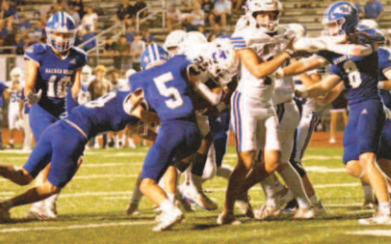 Riley Haas (5) and Ty Noska make the tackle on the Flyers’ Cedric Callis. Chuck Grafe/Tribune-Herald