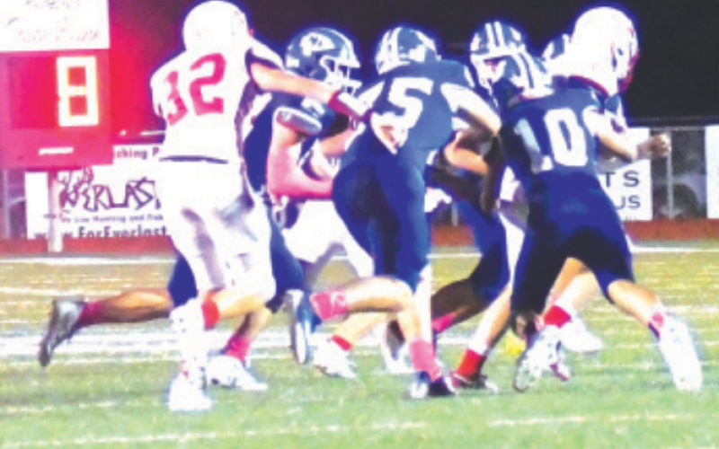 Timber Janak (75) and Kellen Mechura (10) fight off blockers to make a tackle. Chuck Grafe/Tribune-Herald
