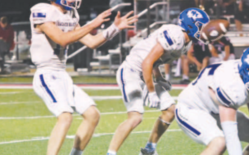 Quarterback Andrew Steffek takes a snap from center during the Temple Aiden Drozd (62) wraps up Columbus’ Bryan Salazar. Chuck Grafe/Tribune-Herald Central Texas game Friday. Photo credit Melissa Kutac